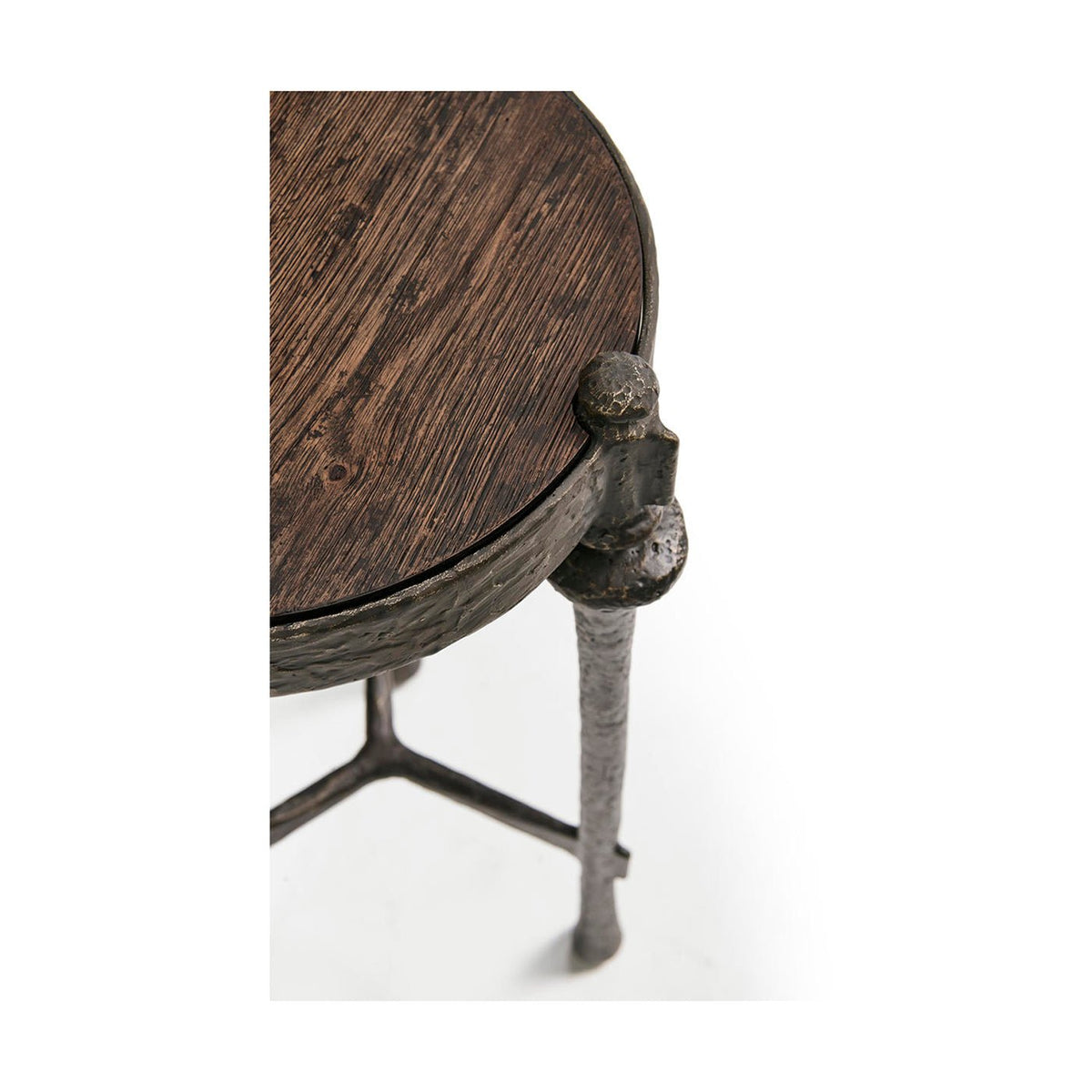 Corner detail of iron and wood round accent table.