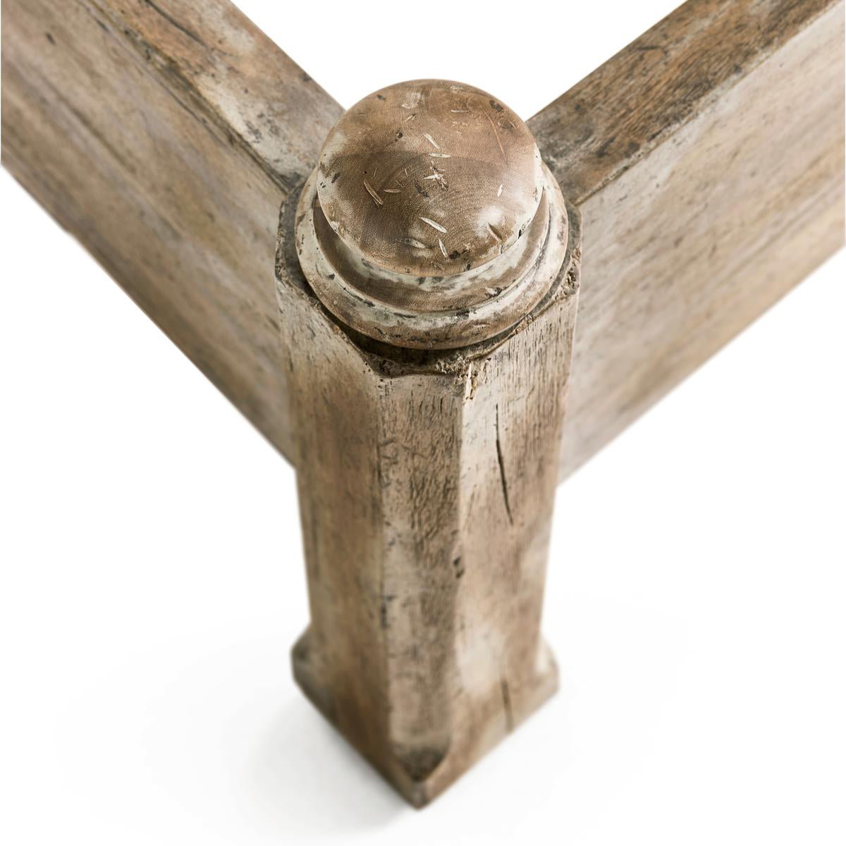 Close-up of rustic wooden bed frame corner detail.