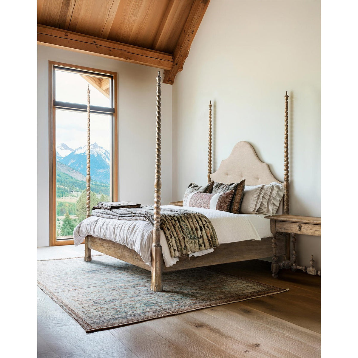 Rustic bed in room with mountain view and decor.